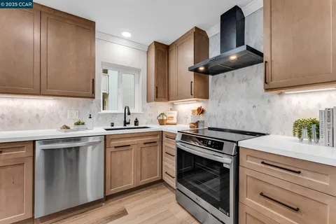 a kitchen with a sink cabinets and stainless steel appliances