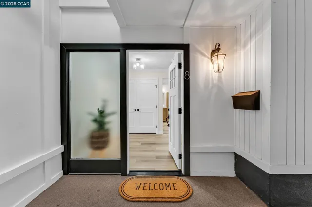 a view of an entryway with wooden floor