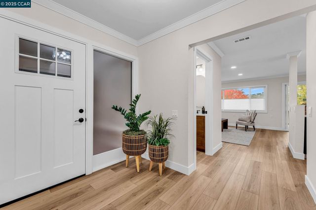 a hallway with wooden floor and furniture