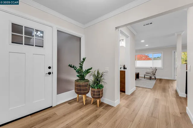 a hallway with wooden floor and furniture