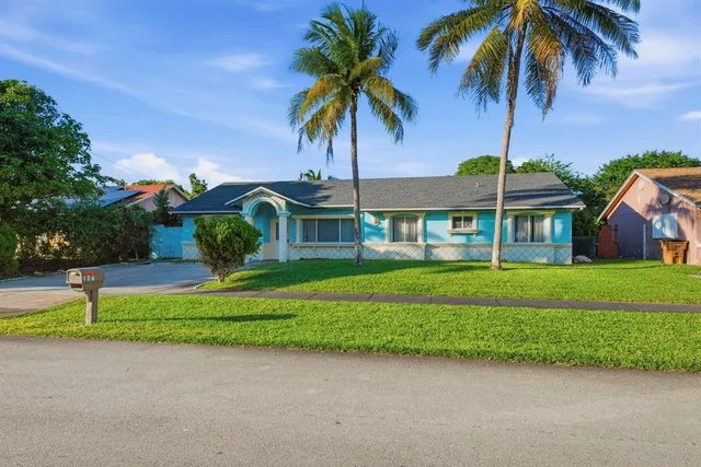 a front view of house with yard and green space