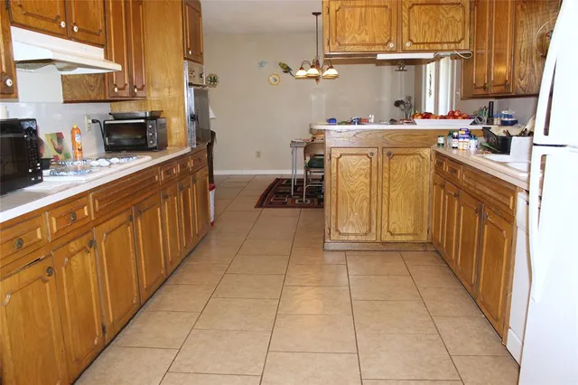a kitchen with stainless steel appliances a sink stove and cabinets