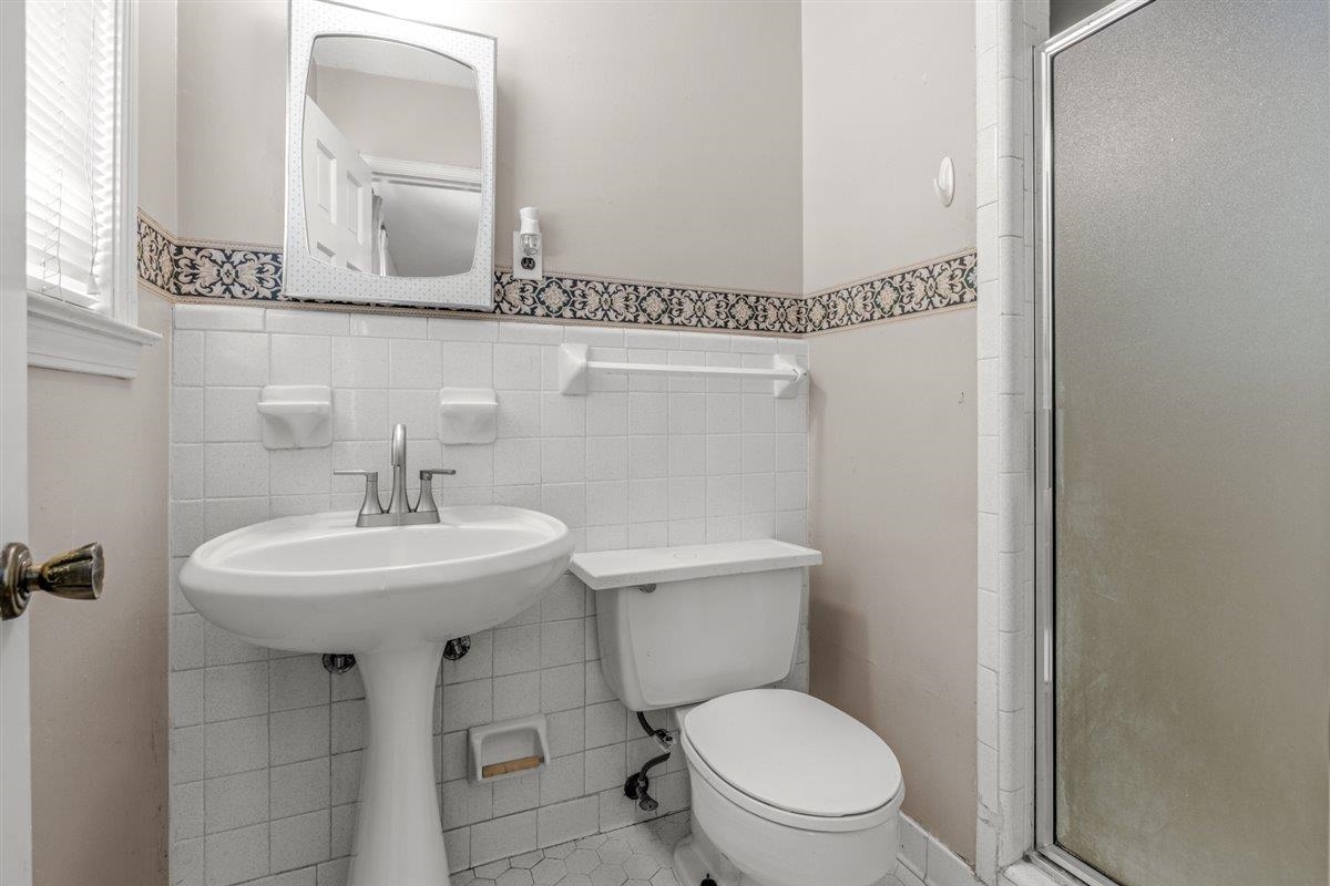 436 Sterling Drive Collierville, TN 38017 - Photo 12 of 40 Full bathroom with a shower stall, tile walls, and a wainscoted wall