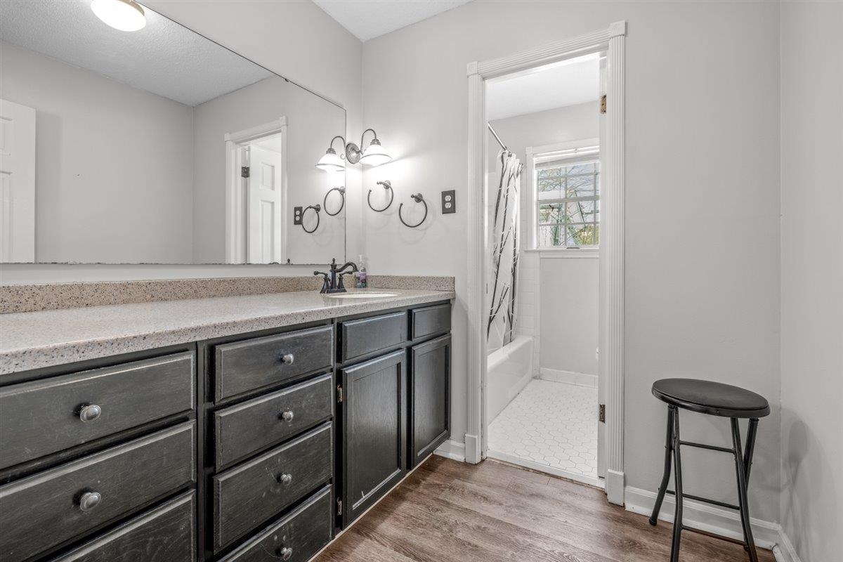 436 Sterling Drive Collierville, TN 38017 - Photo 13 of 40 Bathroom with vanity, shower / tub combo with curtain, and dark wood-style floors