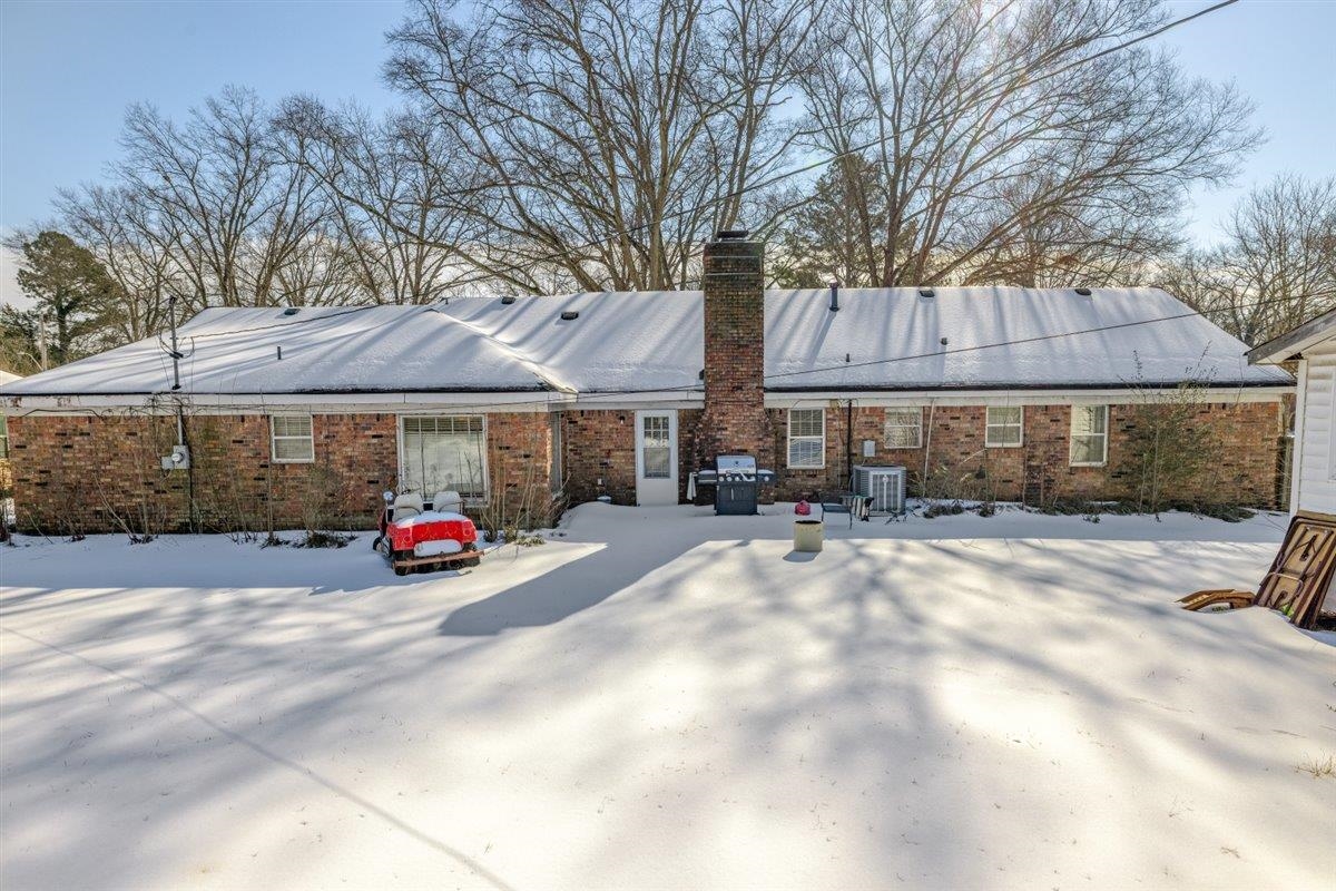 436 Sterling Drive Collierville, TN 38017 - Photo 3 of 40 Snow covered rear of property with a chimney, brick siding, and a patio