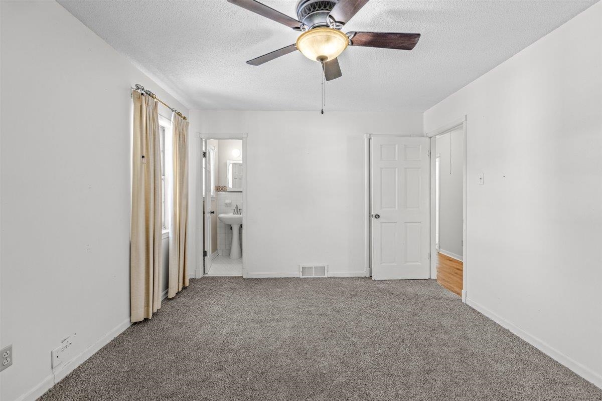 436 Sterling Drive Collierville, TN 38017 - Photo 34 of 40 Unfurnished bedroom with carpet, a textured ceiling, connected bathroom, and a ceiling fan