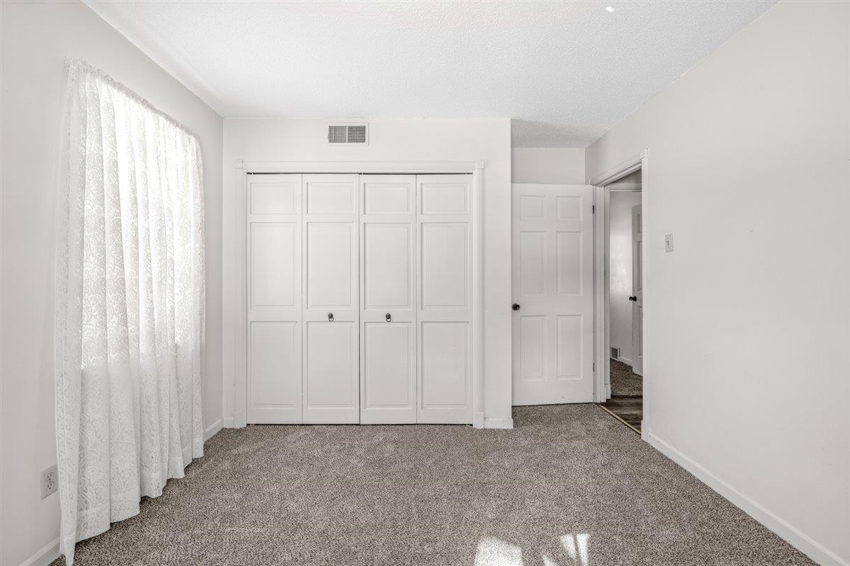 436 Sterling Drive Collierville, TN 38017 - Photo 36 of 40 Unfurnished bedroom featuring a closet, carpet, and a textured ceiling