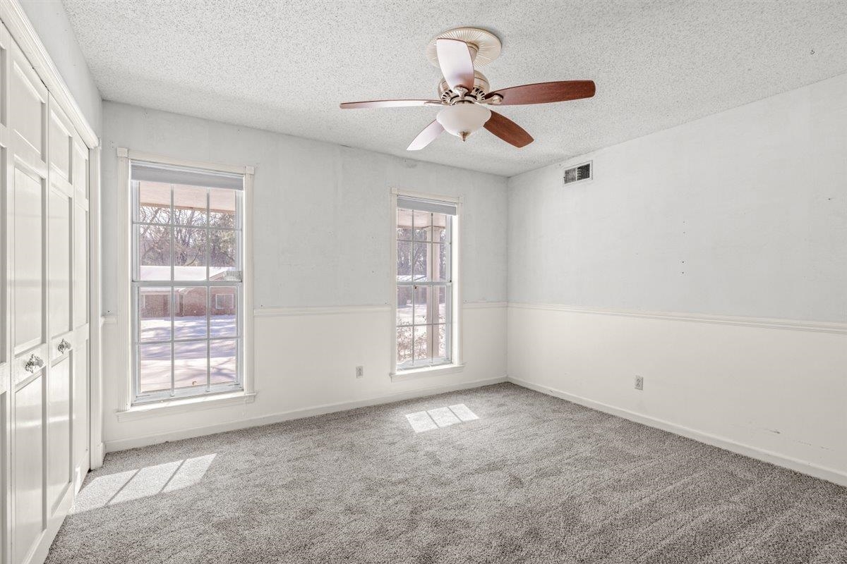 436 Sterling Drive Collierville, TN 38017 - Photo 39 of 40 Unfurnished bedroom featuring a closet, light colored carpet, a textured ceiling, and a ceiling fan