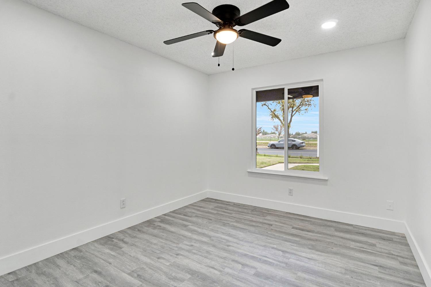 2808 Riverview Drive Madera, CA 93637 - Photo 23 of 35 empty room featuring a textured ceiling, light wood-style floors, a ceiling fan, and recessed lighting