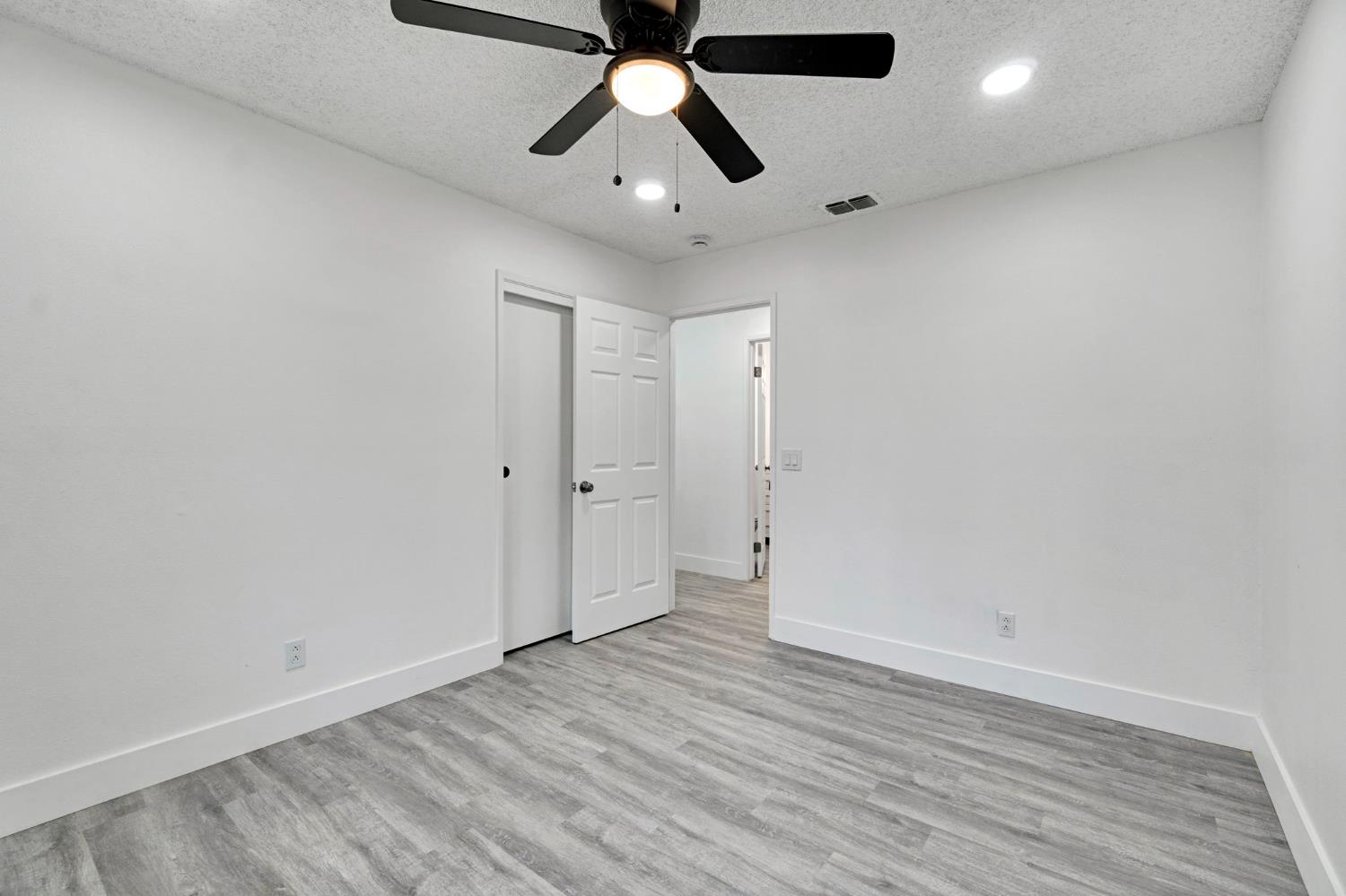 2808 Riverview Drive Madera, CA 93637 - Photo 24 of 35 unfurnished bedroom featuring a textured ceiling, light wood-type flooring, ceiling fan, and recessed lighting
