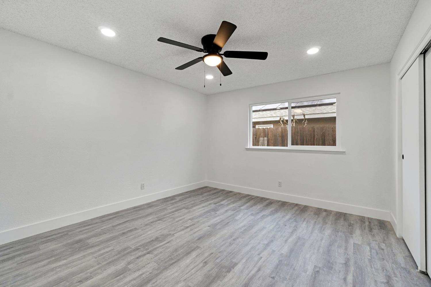 2808 Riverview Drive Madera, CA 93637 - Photo 26 of 35 unfurnished bedroom featuring a closet, light wood-type flooring, recessed lighting, a textured ceiling, and ceiling fan