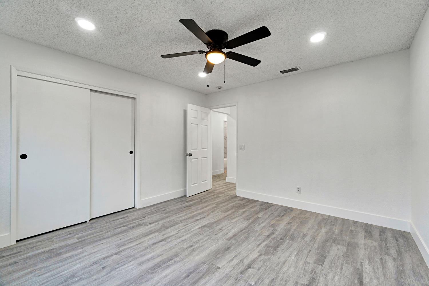 2808 Riverview Drive Madera, CA 93637 - Photo 27 of 35 unfurnished bedroom featuring recessed lighting, a textured ceiling, ceiling fan, a closet, and light wood-style flooring
