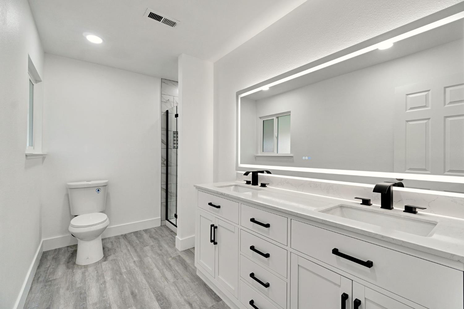 2808 Riverview Drive Madera, CA 93637 - Photo 30 of 35 bathroom featuring double vanity, a shower stall, recessed lighting, and light wood finished floors