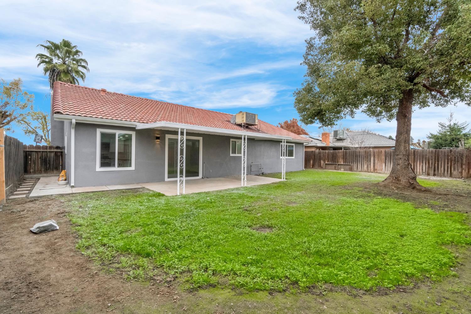 2808 Riverview Drive Madera, CA 93637 - Photo 33 of 35 rear view of house featuring a patio, a fenced backyard, and stucco siding