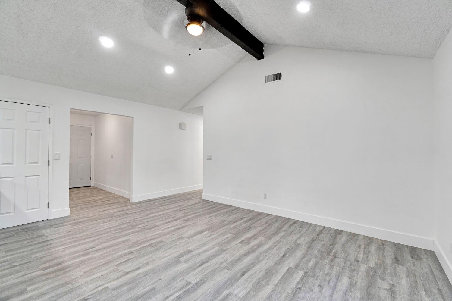 2808 Riverview Drive Madera, CA 93637 - Photo 7 of 35 unfurnished room with a textured ceiling, light wood-type flooring, ceiling fan, and recessed lighting