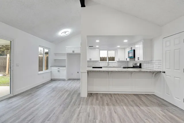 a view of kitchen with wooden floor and window
