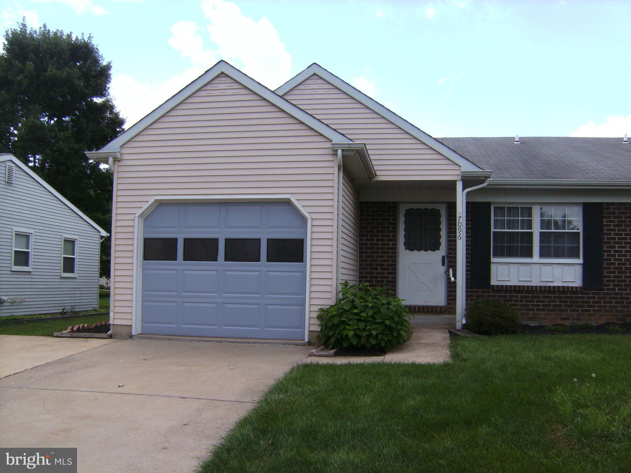 7096 Catalpa Road Frederick, MD 21703 - Photo 1 of 20 a front view of a house with a garden