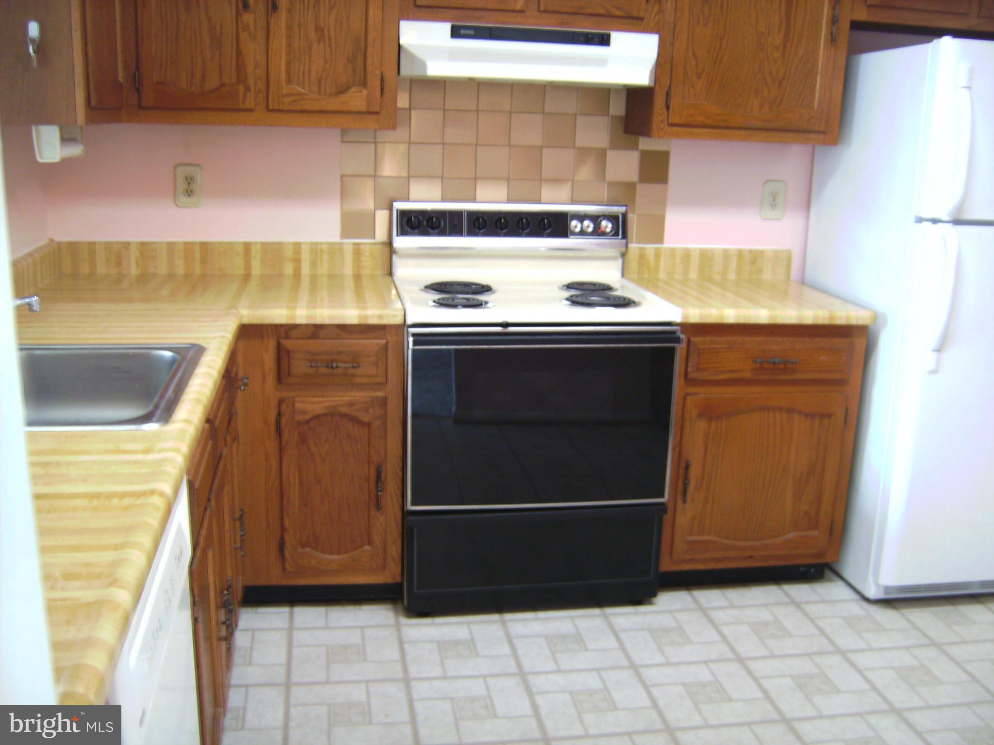 7096 Catalpa Road Frederick, MD 21703 - Photo 11 of 20 a kitchen with a stove and a cabinet