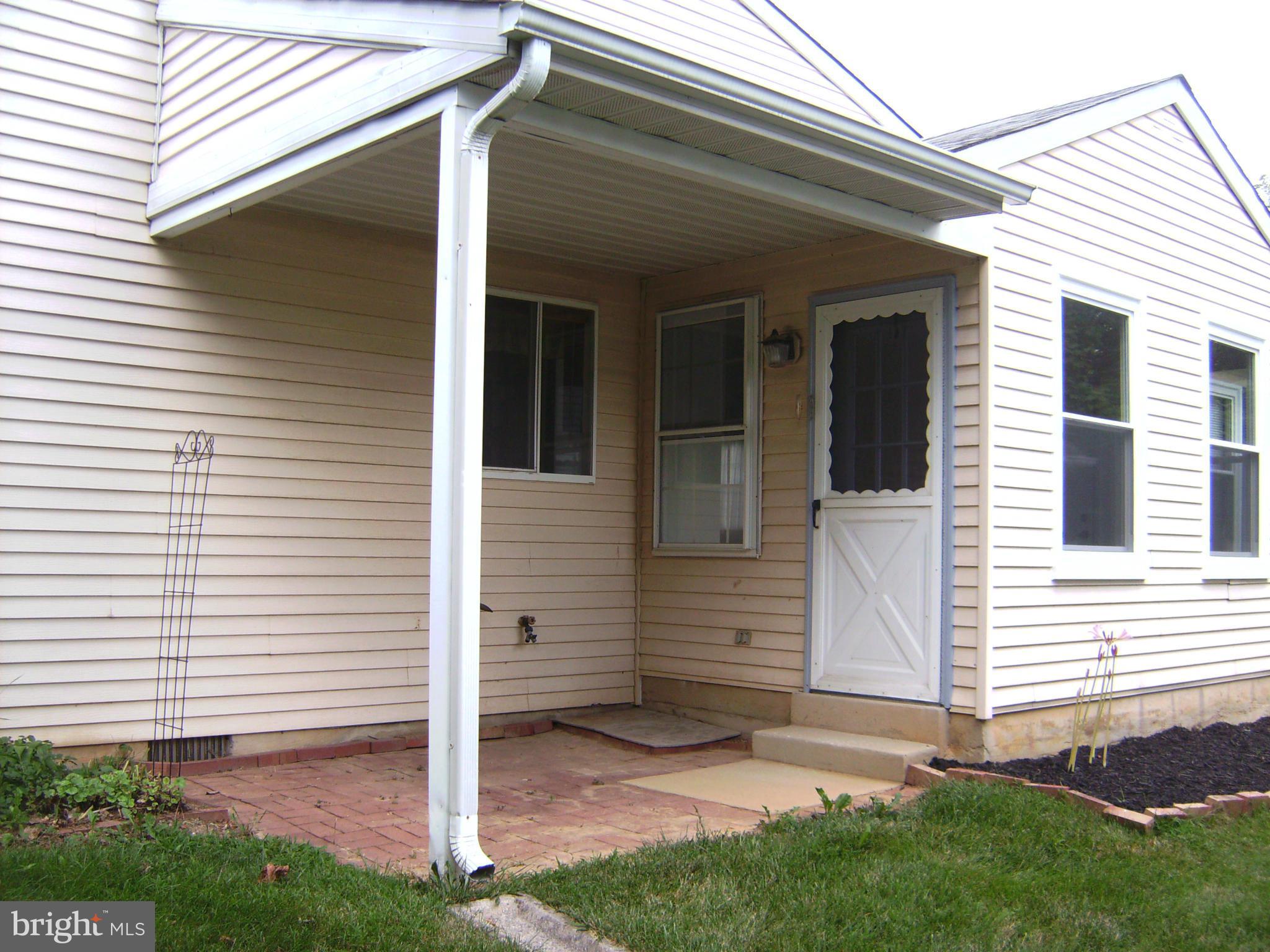 7096 Catalpa Road Frederick, MD 21703 - Photo 18 of 20 a view of a white house with a small cabin