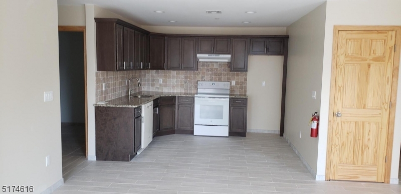 67 Main Street, Unit 2 Stanhope, NJ 07874 - Photo 3 of 19 a kitchen with stainless steel appliances granite countertop a refrigerator and a sink