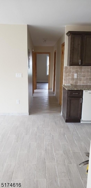 67 Main Street, Unit 2 Stanhope, NJ 07874 - Photo 5 of 19 a view of a kitchen with furniture and a fireplace