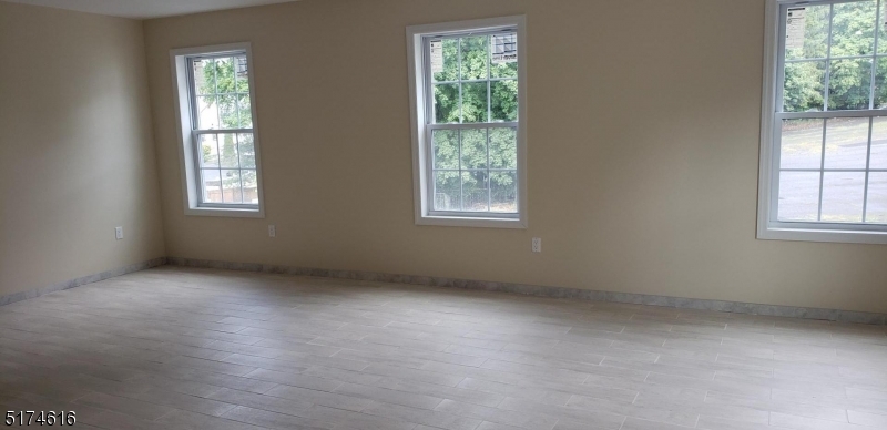 67 Main Street, Unit 2 Stanhope, NJ 07874 - Photo 6 of 19 an empty room with windows
