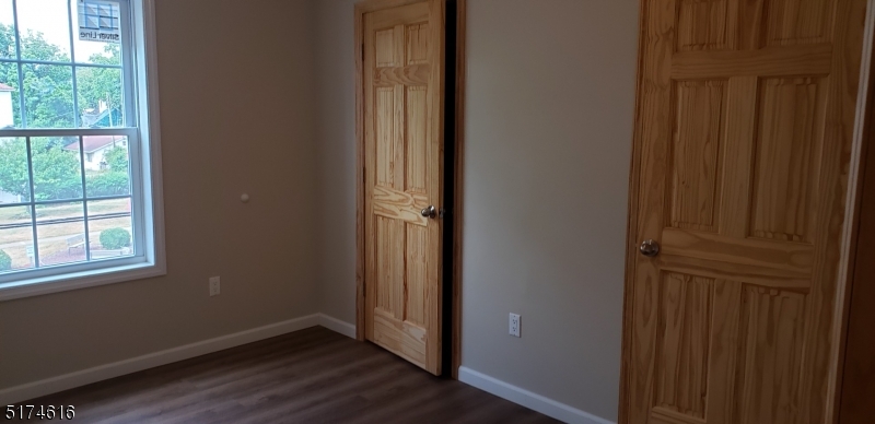 67 Main Street, Unit 2 Stanhope, NJ 07874 - Photo 7 of 19 an empty room with wooden floor and a window