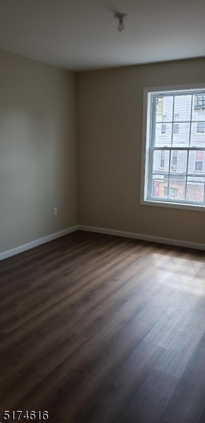 67 Main Street, Unit 2 Stanhope, NJ 07874 - Photo 8 of 19 an empty room with wooden floor and windows