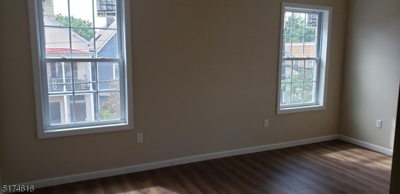 67 Main Street, Unit 2 Stanhope, NJ 07874 - Photo 9 of 19 a view of an empty room with wooden floor and a window