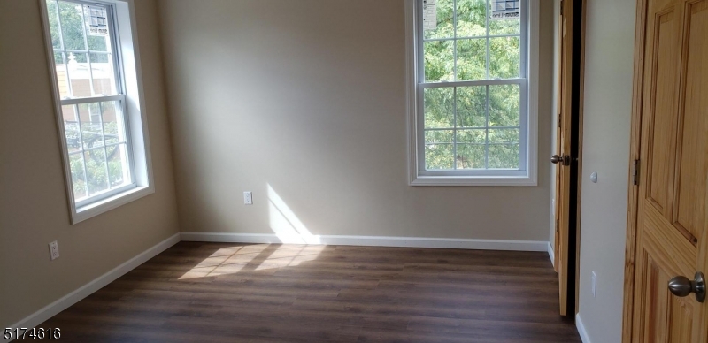67 Main Street, Unit 2 Stanhope, NJ 07874 - Photo 10 of 19 a view of wooden floor in an empty room with a window