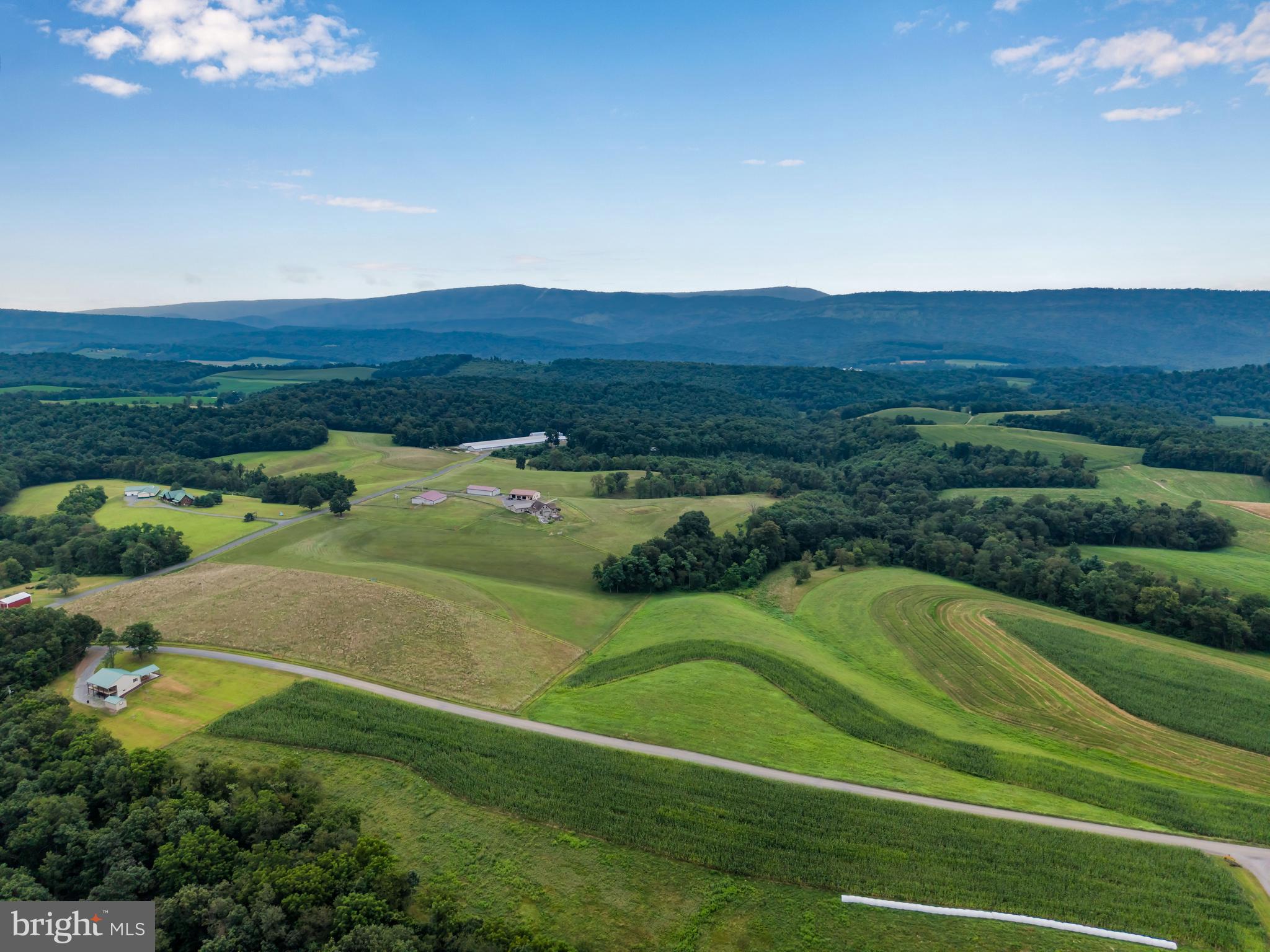 729 Gloss Road East Waterford, PA 17021 - Photo 19 of 70 a view of a golf course with a lake in the background