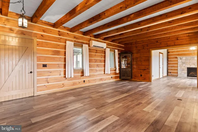 a view of a room with window a ceiling fan and front door