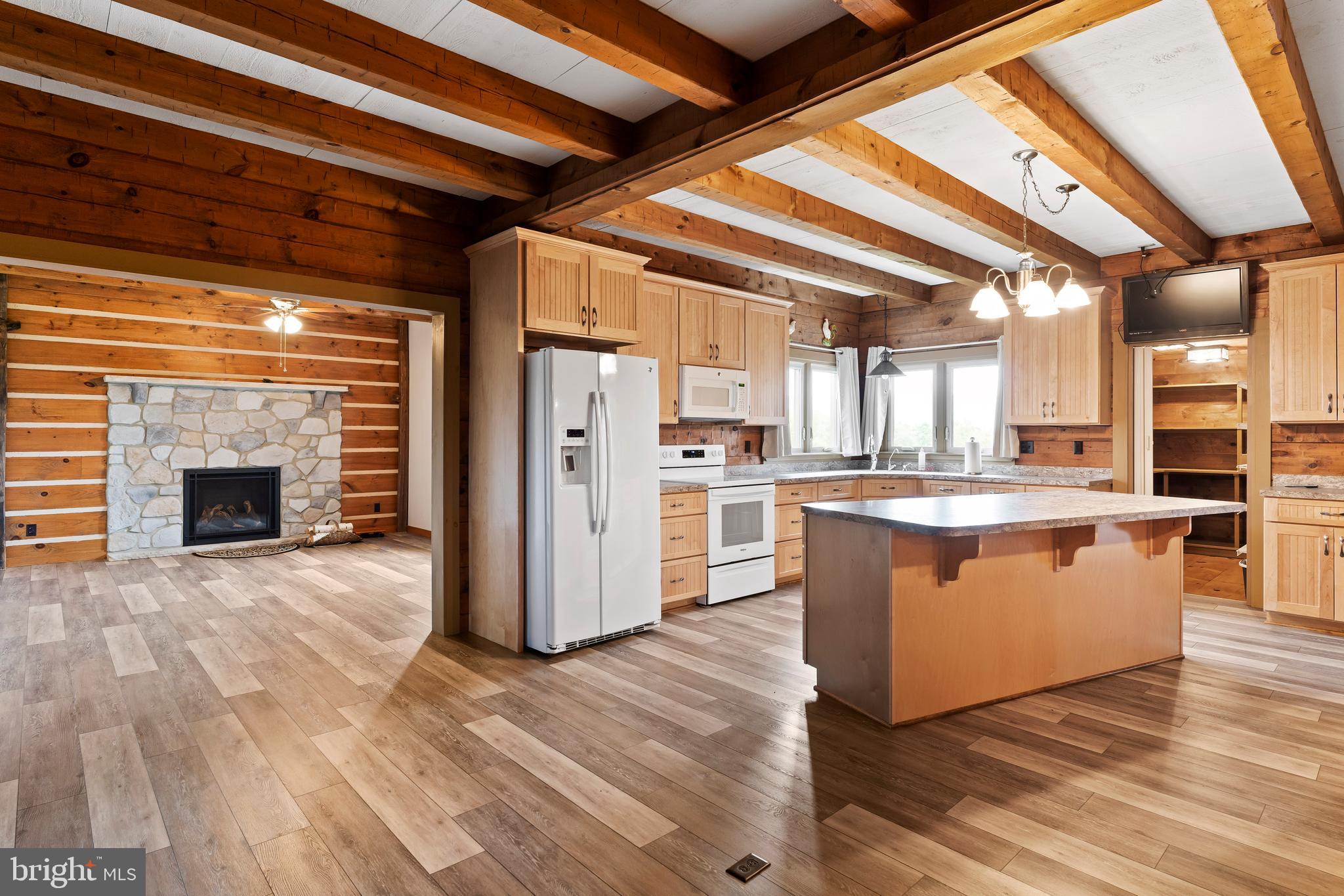 729 Gloss Road East Waterford, PA 17021 - Photo 29 of 70 a view of kitchen with stainless steel appliances wooden floor and chandelier