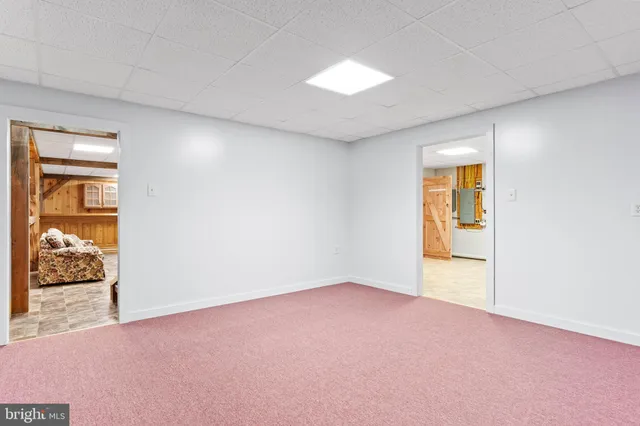 a view of garage with a refrigerator and a car parked