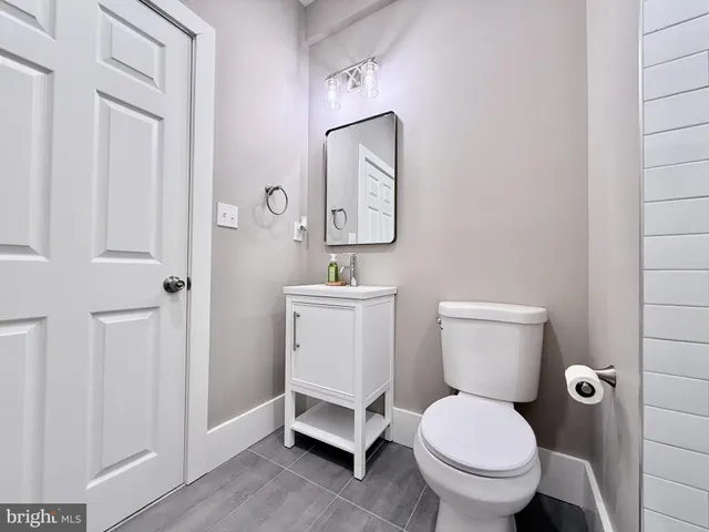 a white toilet sitting next to a bathroom sink