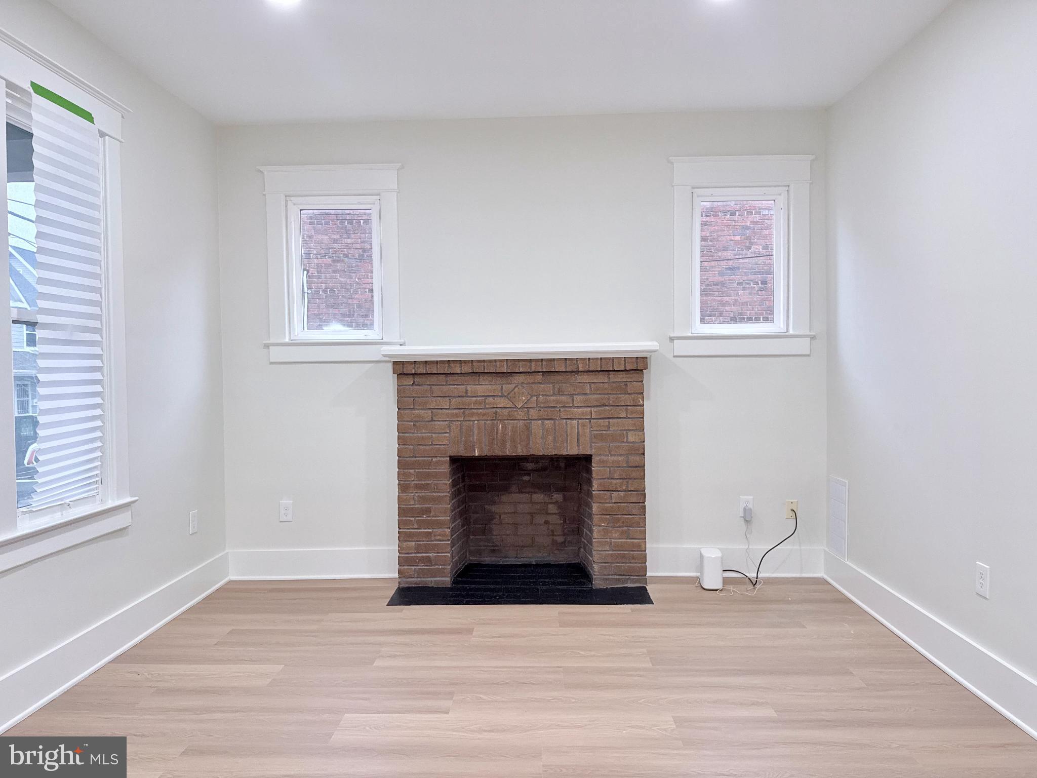 610 Raleigh Place Southeast Washington, DC 20032 - Photo 7 of 15 a living room with a fireplace and a wooden floor