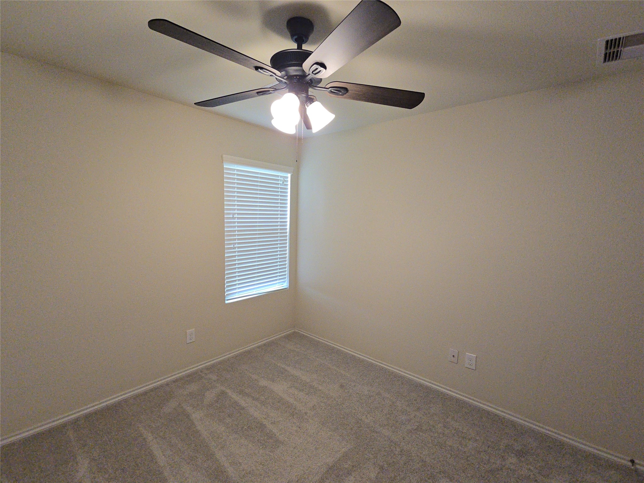 810 Lightningbug Lane Conroe, TX 77301 - Photo 11 of 27 an empty room with a window and a fan