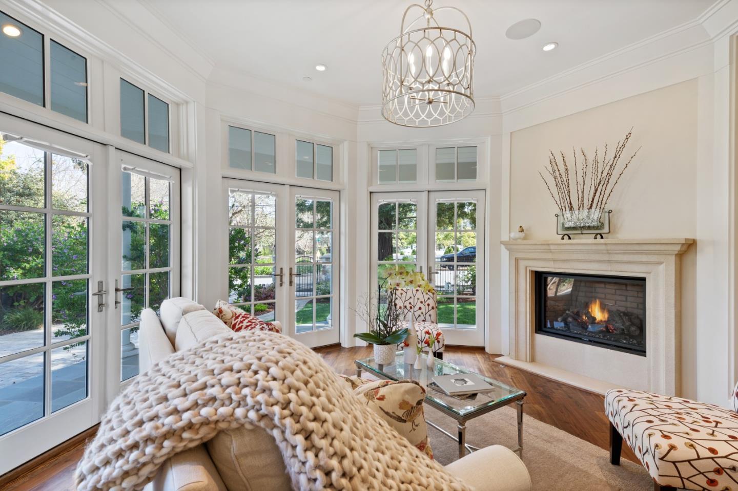 88 Warren Road San Mateo, CA 94401 - Photo 12 of 50 a living room with furniture a fireplace and a chandelier