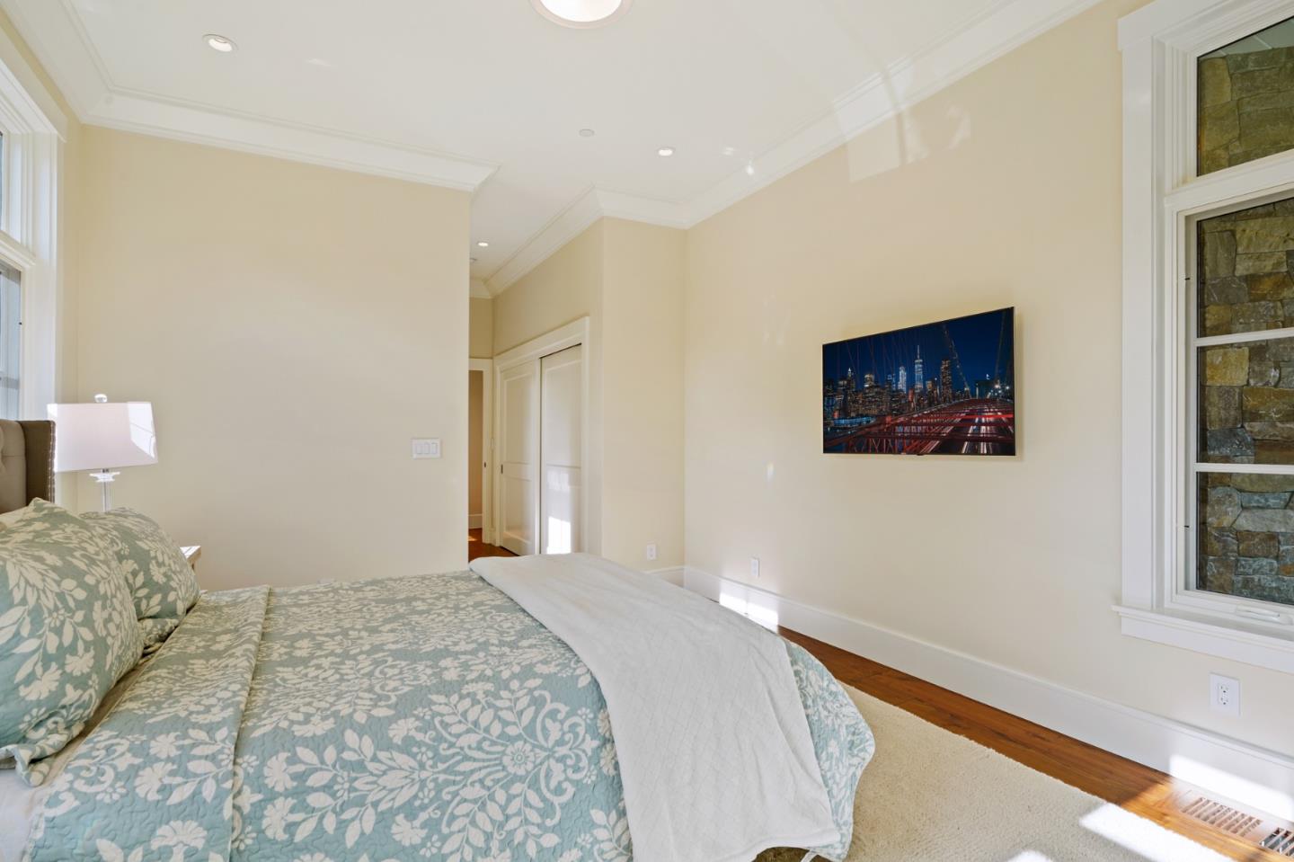 88 Warren Road San Mateo, CA 94401 - Photo 41 of 50 a bedroom with a bed and a painting on the wall