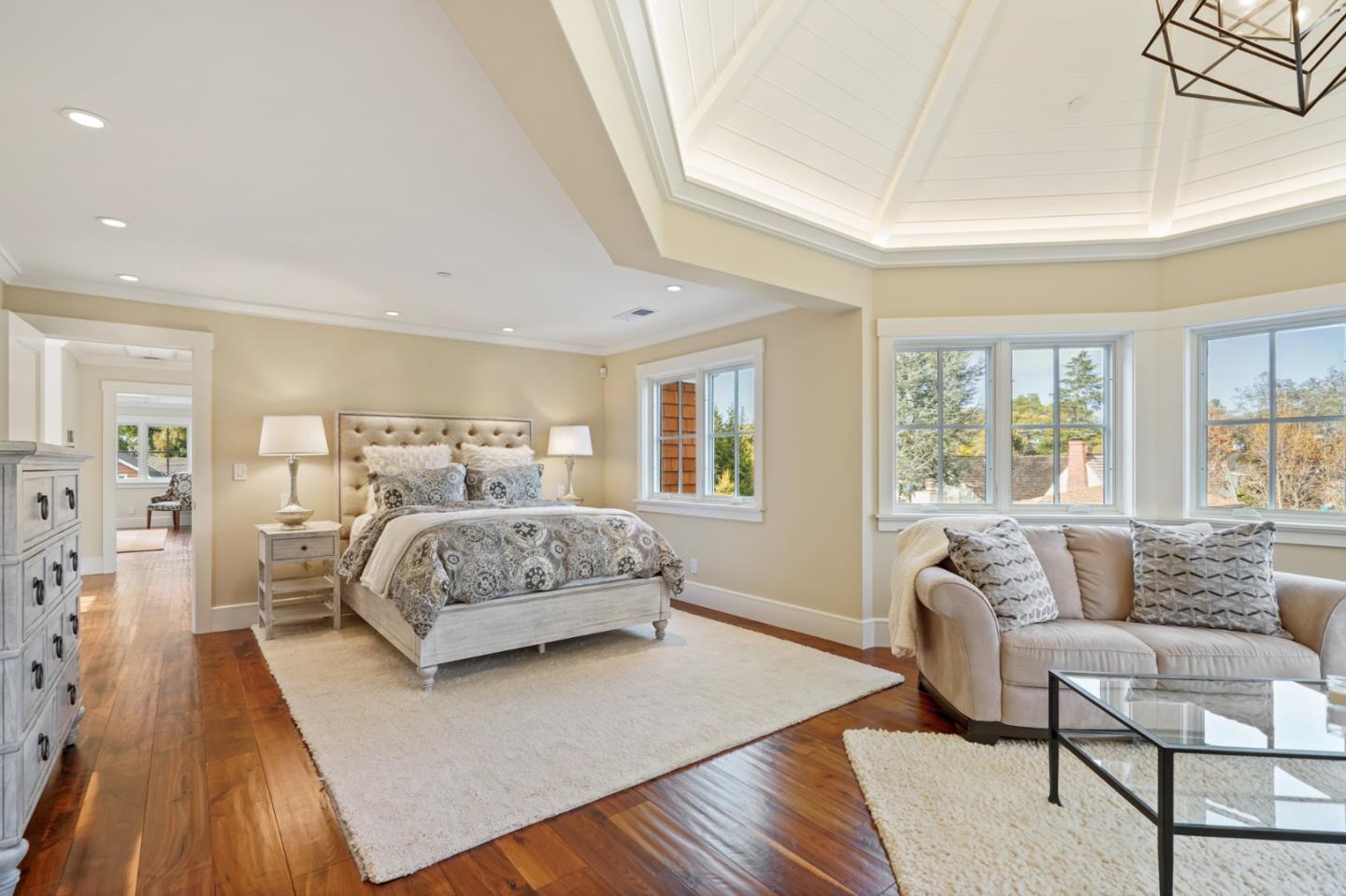 88 Warren Road San Mateo, CA 94401 - Photo 45 of 50 a bedroom with a large bed a couch and two large window