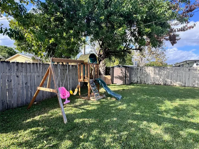 a view of a backyard with a table and chair