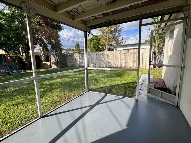 a view of a porch with furniture and garden