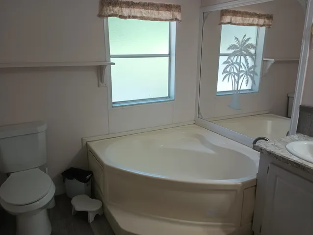 a white bath tub sitting next to a toilet
