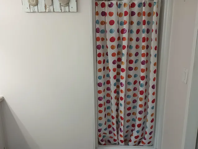 a bathroom with a black and white shower curtain