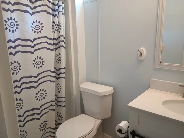 a white toilet sitting next to a bathroom sink