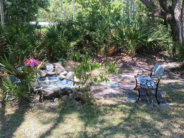 a backyard of a house with table and chairs
