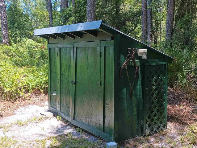 a view of a wooden door and a yard