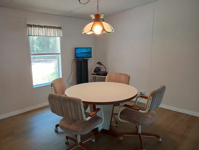 a view of a dining room with furniture and window