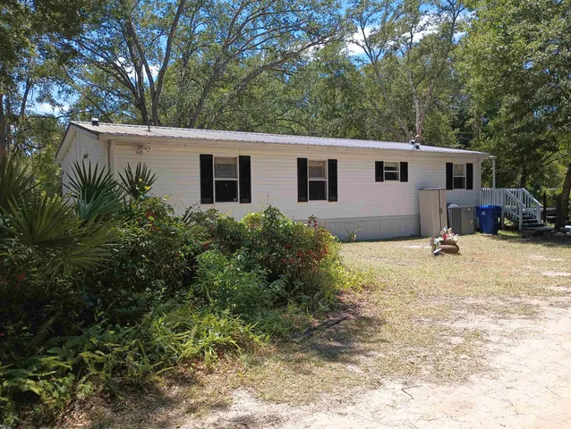 a view of a house with a yard covered in snow
