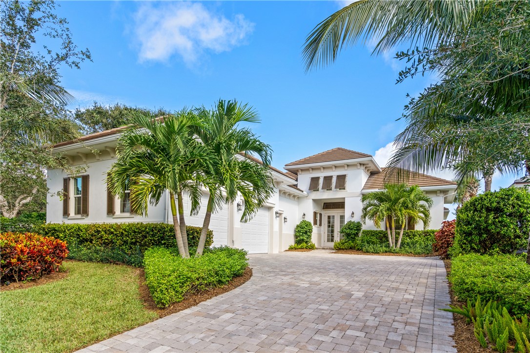 11 Caribe Way Vero Beach, FL 32963 - Photo 1 of 34 a front view of a house with a garden
